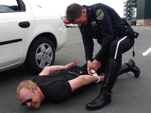 Adam Savage being handcuffed