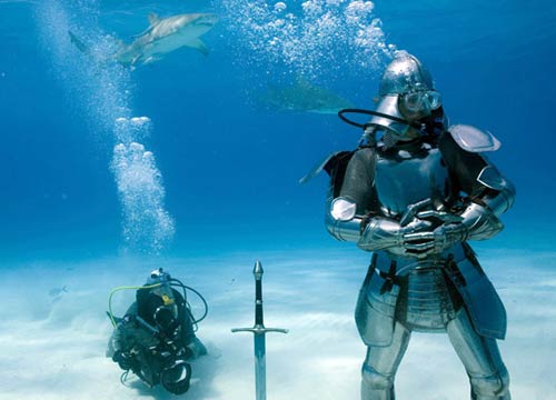 Adam Savage wearing armor underwater