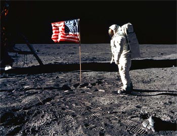 Buzz Aldrin in front of flag Apollo 11